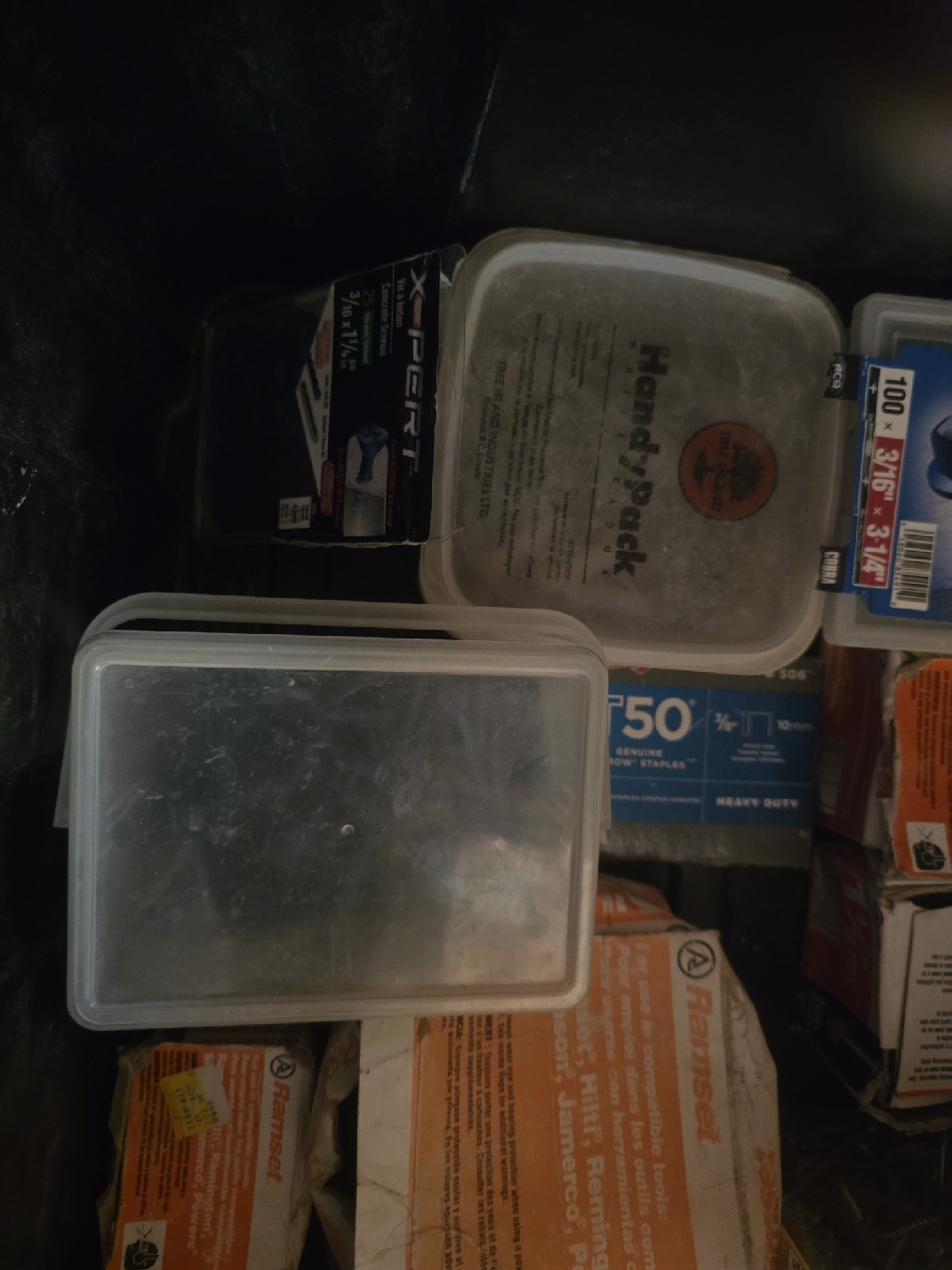 Black container full of concrete screws and Ramset shot nails - photo 5