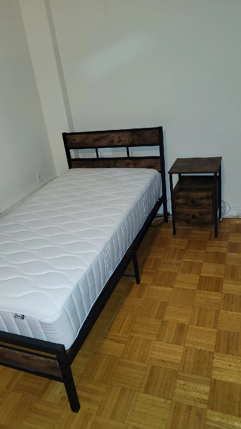 Twin bed with mattress and nightstand
