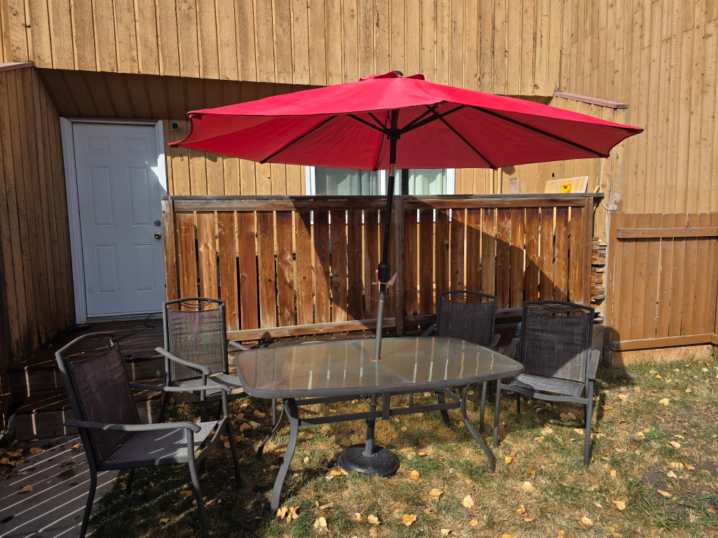 patio table and chairs with an umbrella