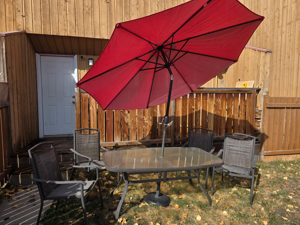 patio table and chairs with an umbrella - photo 2