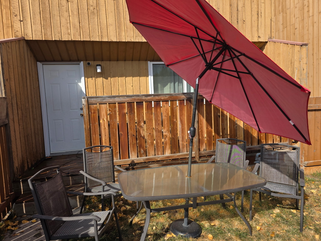 patio table and chairs with an umbrella - photo 5