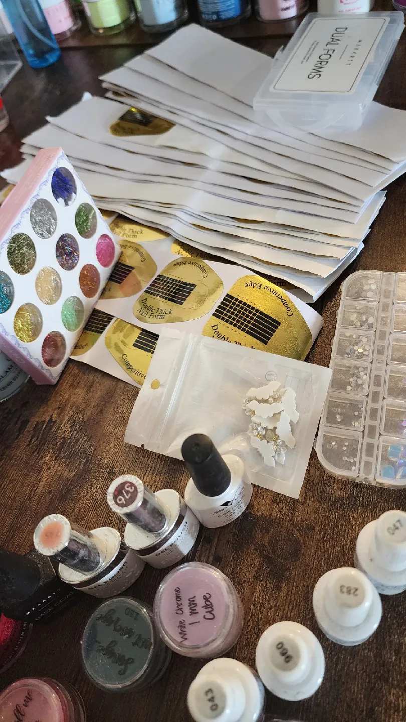 Variety of Nail Art Supplies: Powders, Gels, Glitters image indicator(9)