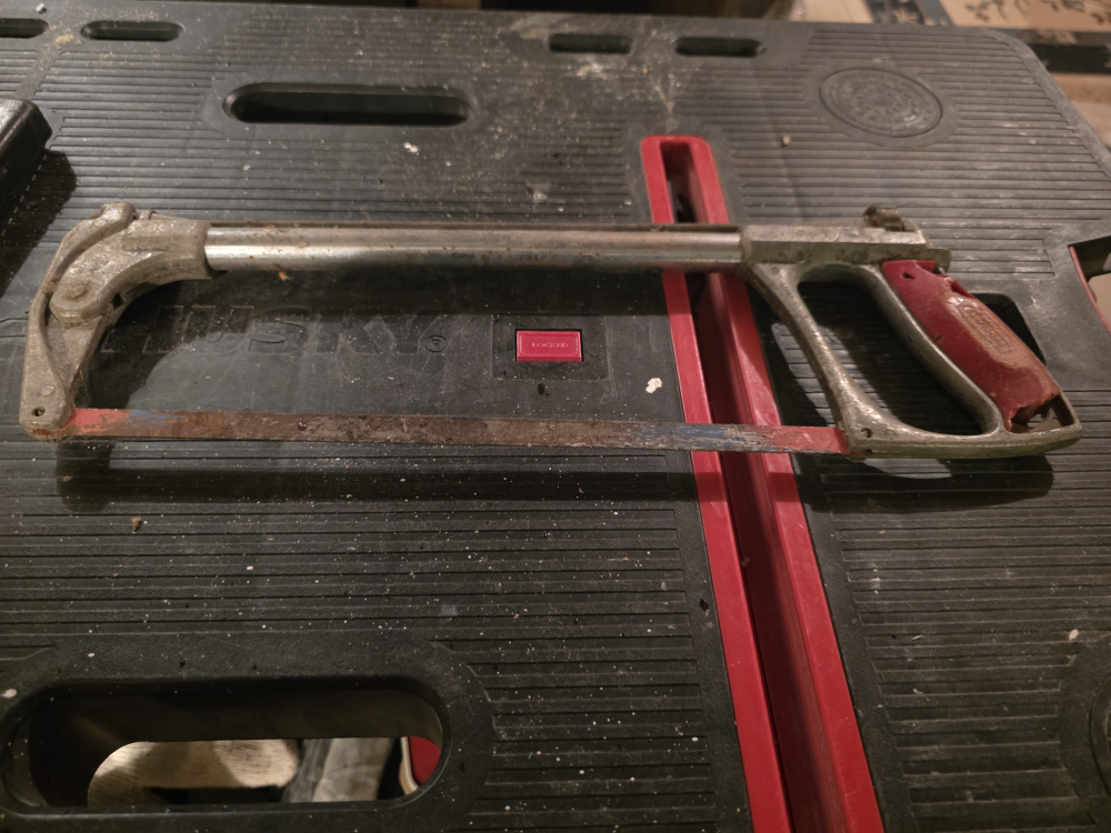 Used Hacksaw with Red Handle