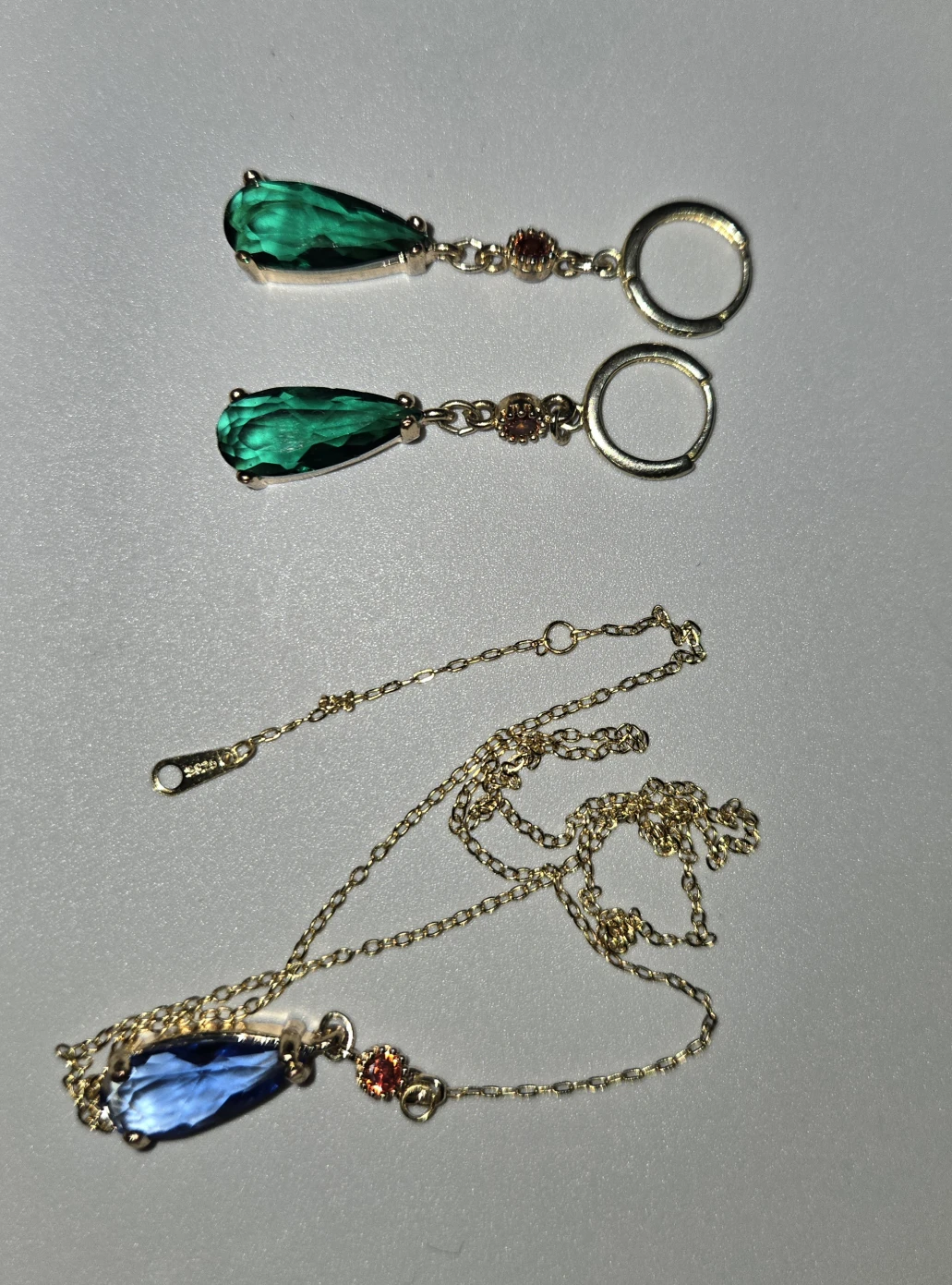 silver jewelry with emerald-type stones