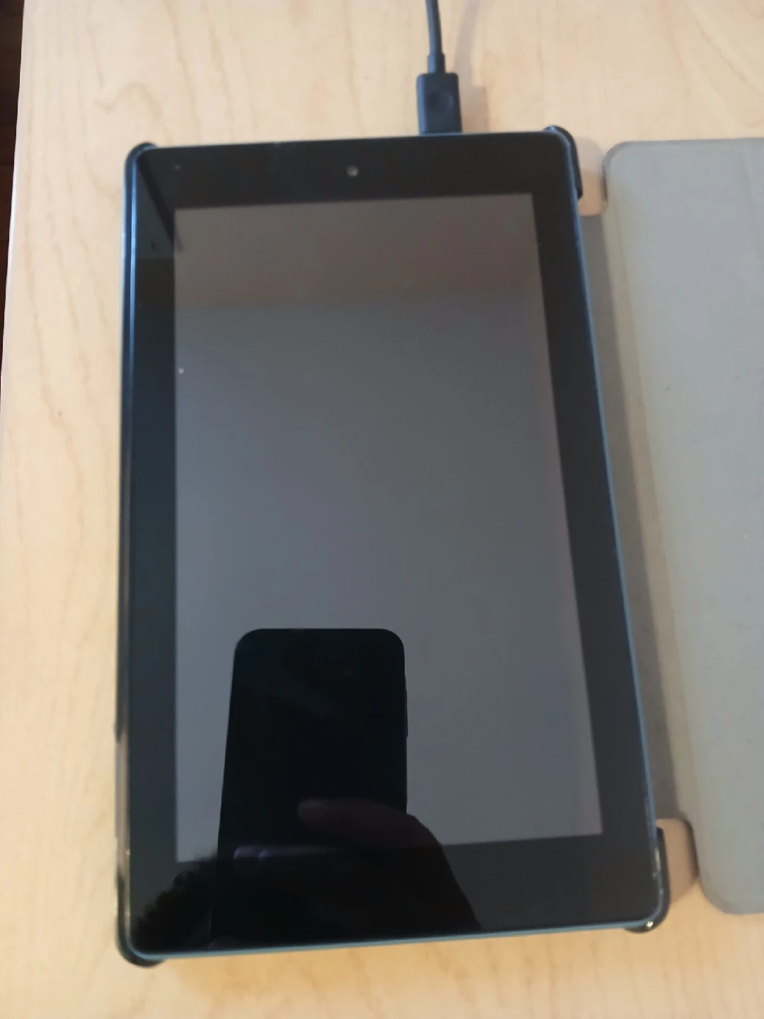 Black tablet with a charger