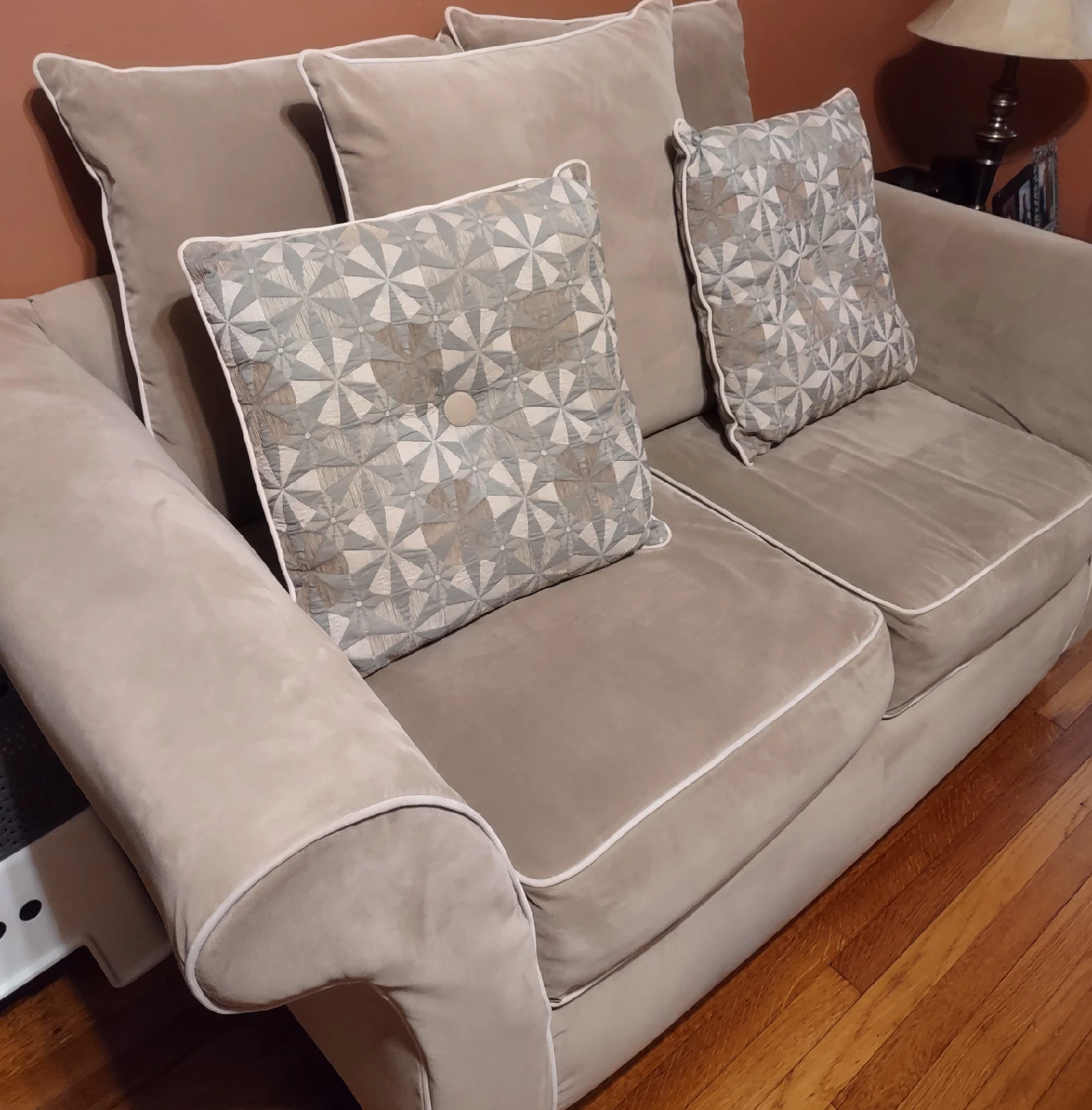 2 Tan Loveseat Sofas with Patterned Pillows