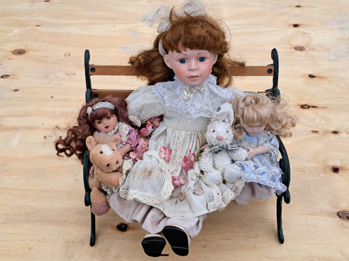 Porcelain Dolls on Bench