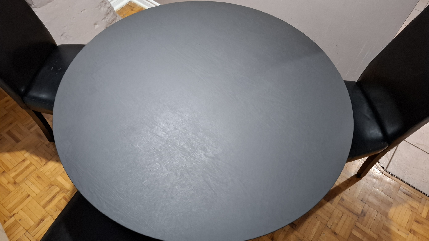 Round matt black wooden dining table with 3 black chairs - photo 2