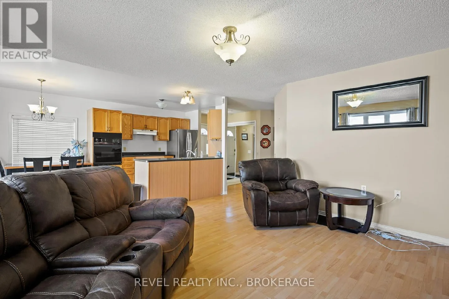 Couch, chair, end tabl,fireplace. image indicator(8)