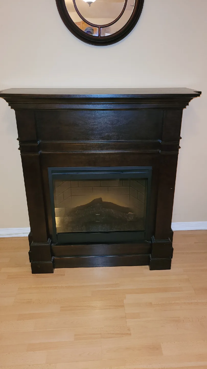 Couch, chair, end tabl,fireplace. image indicator(7)