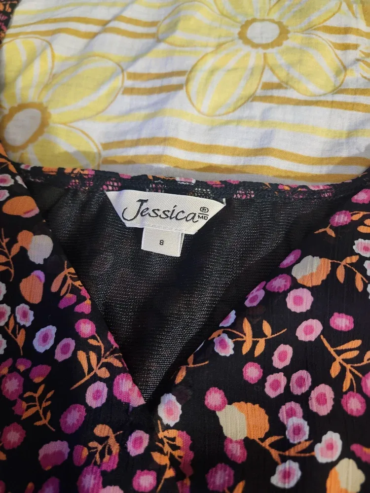 Black and pink floral babydoll top with a bow at the back image indicator(4)