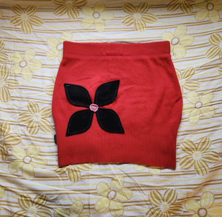 Red and black Bum Warmer mini sweater skirt with flower detail
