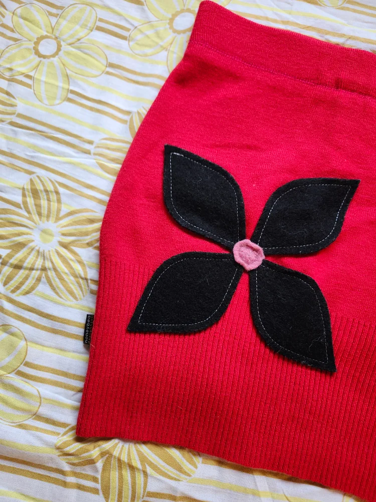Red and black Bum Warmer mini sweater skirt with flower detail image indicator(3)