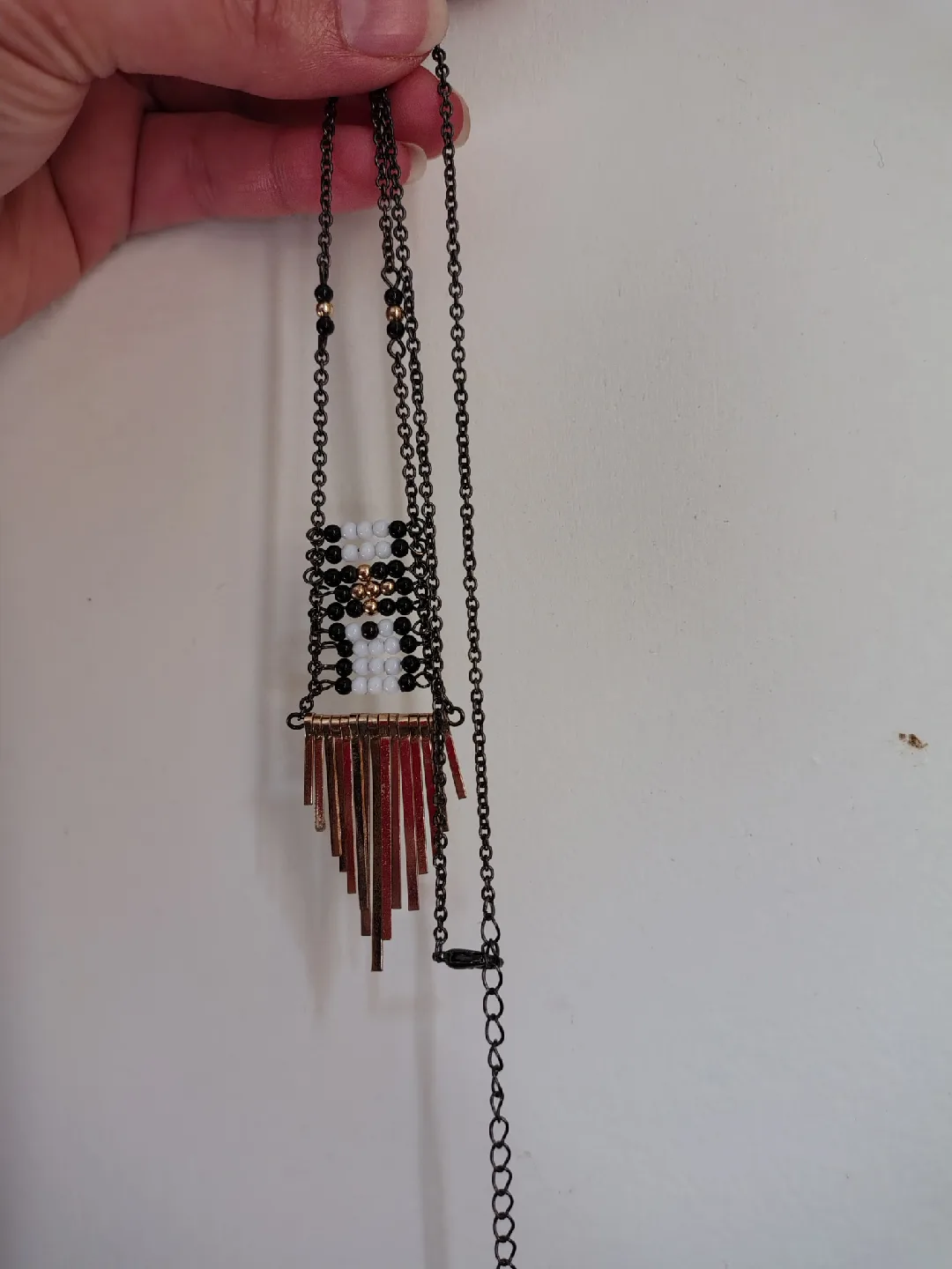 Necklace with gold and black accents image indicator(2)