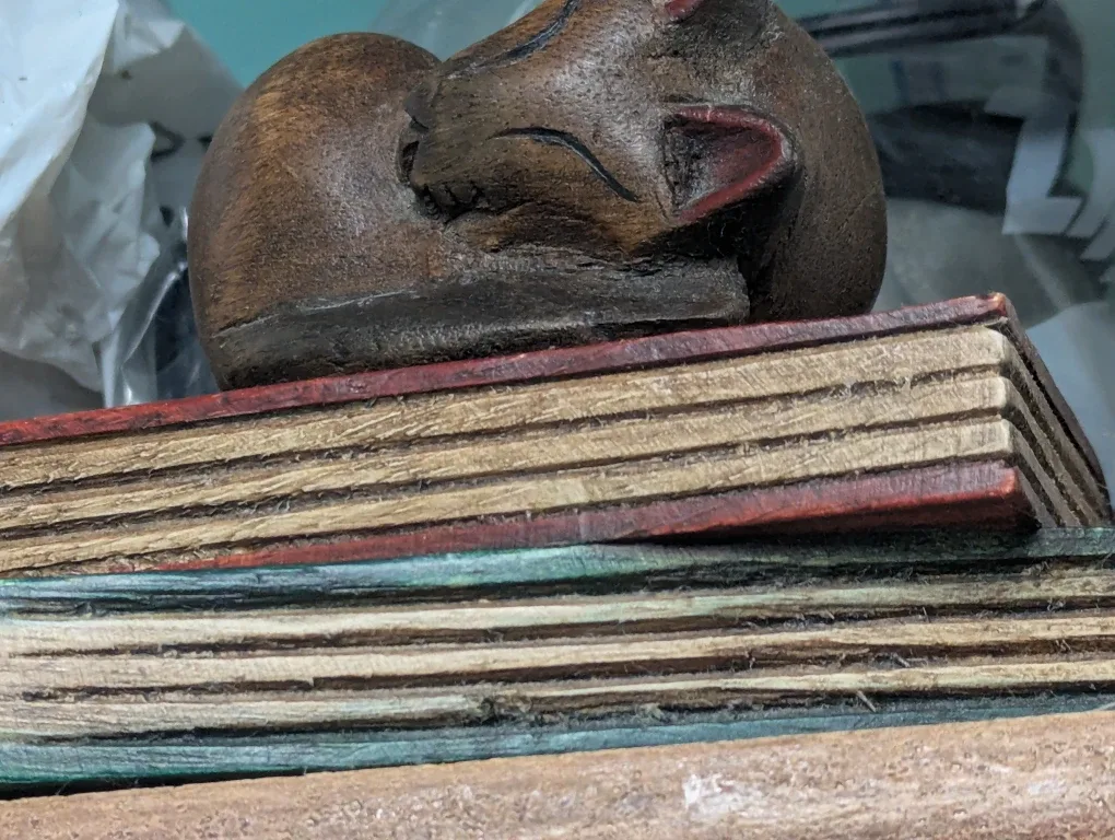 Wooden Cat Figurine on Books