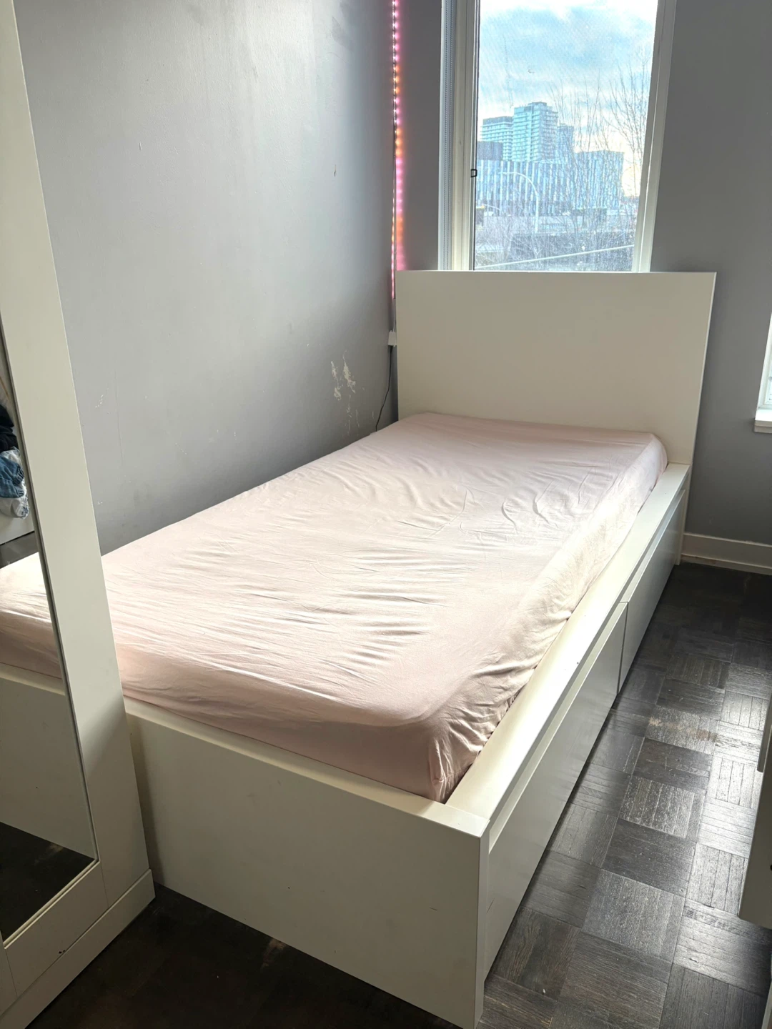 White twin bed with two drawers for storage