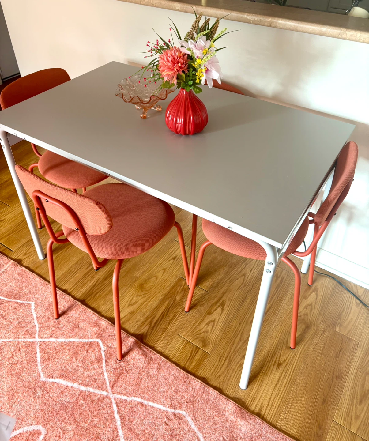Grey Table with 4 Orange Chairs