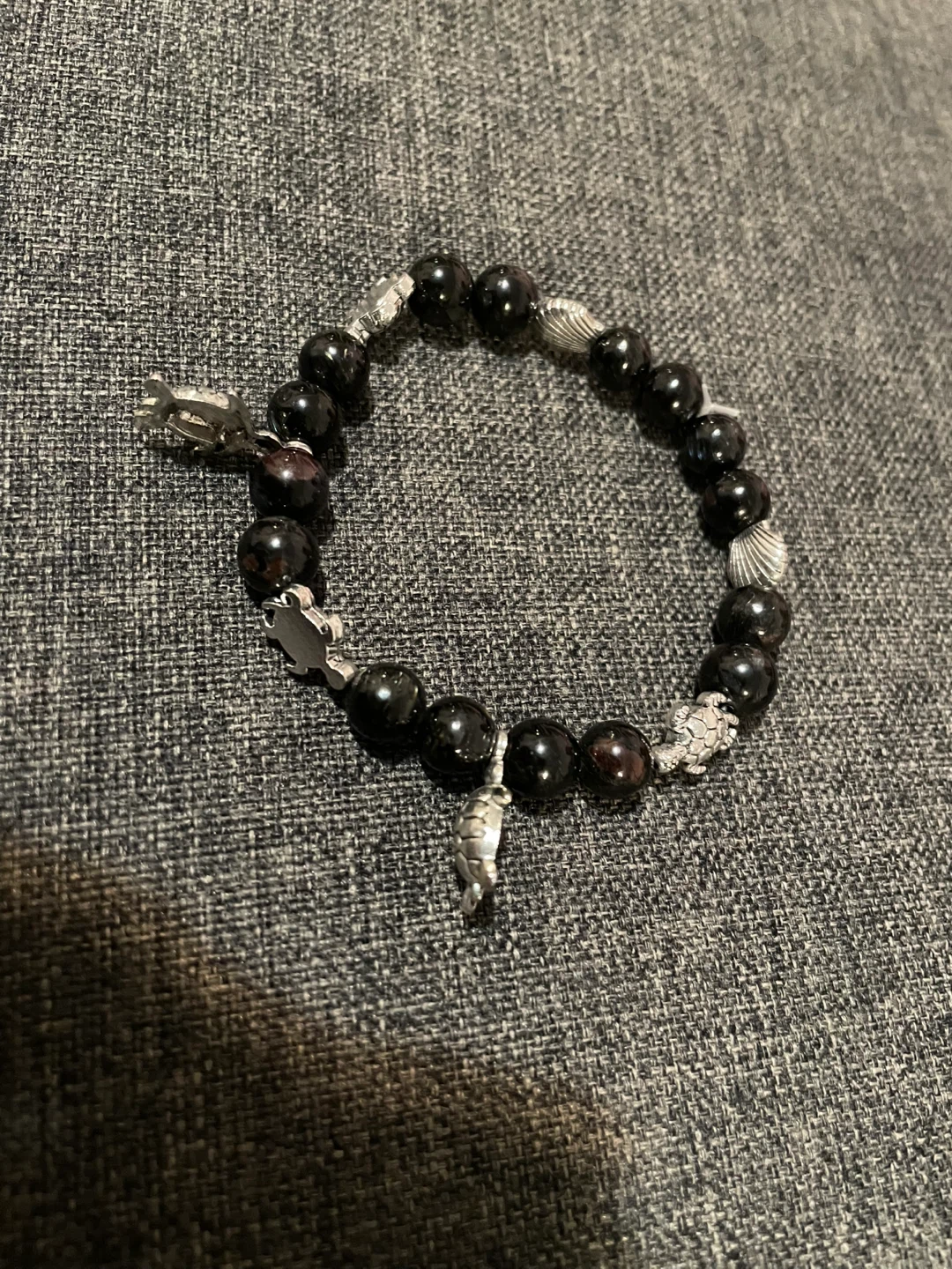 black obsidian beaded bracelet with silver charm