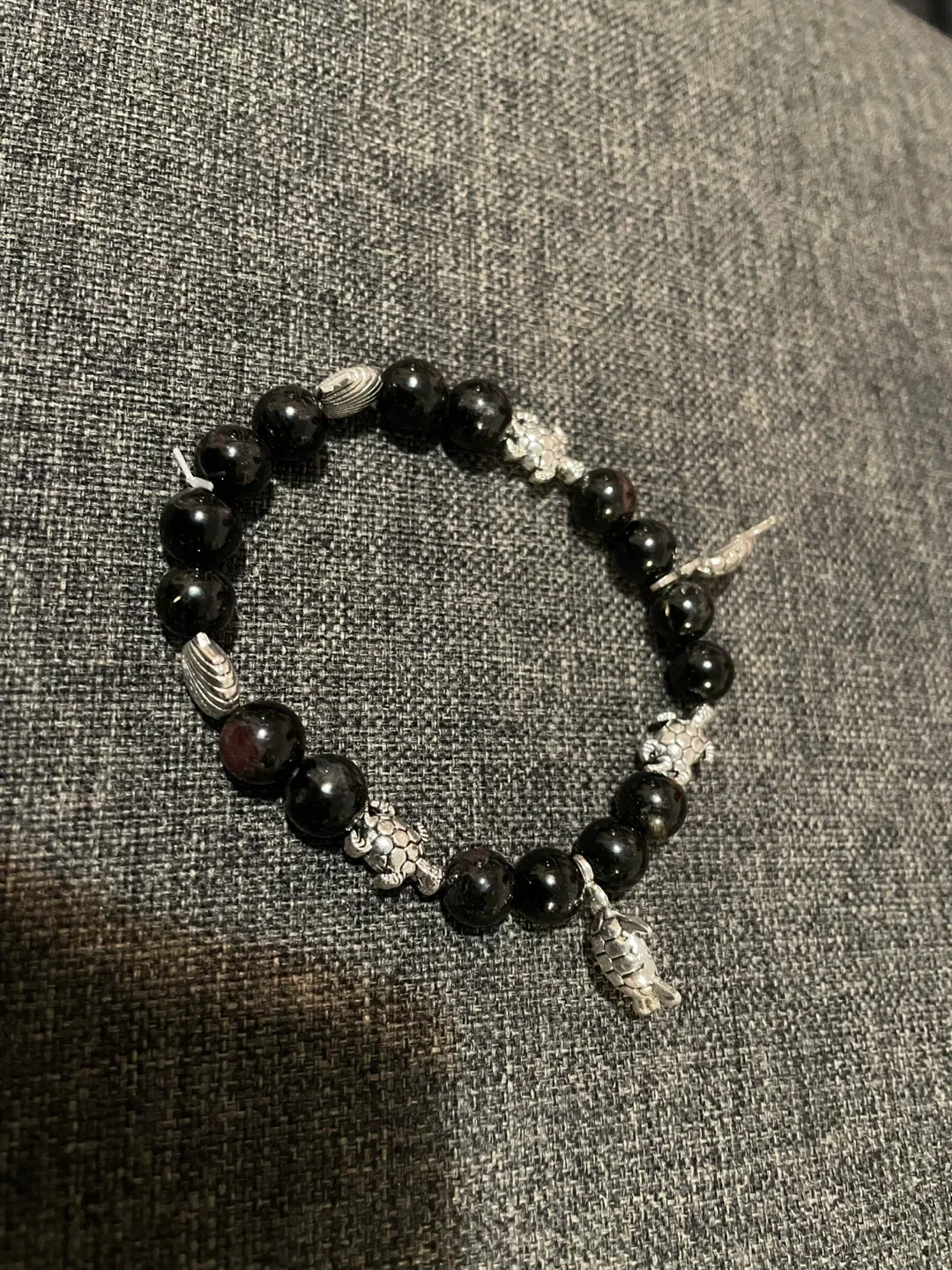 black obsidian beaded bracelet with silver charm image indicator(2)