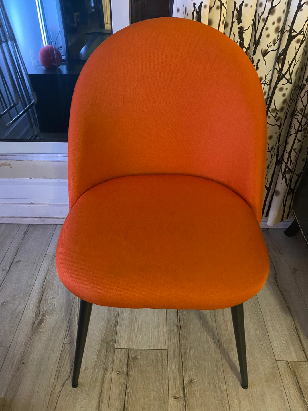 Orange chair with black legs