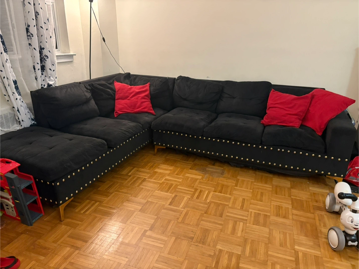 Black Sectional Sofa with Red Pillows