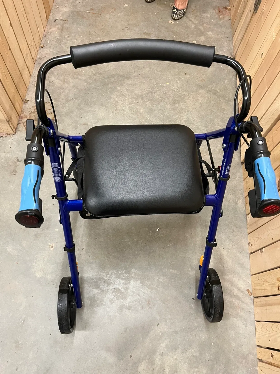 Blue four wheel walker