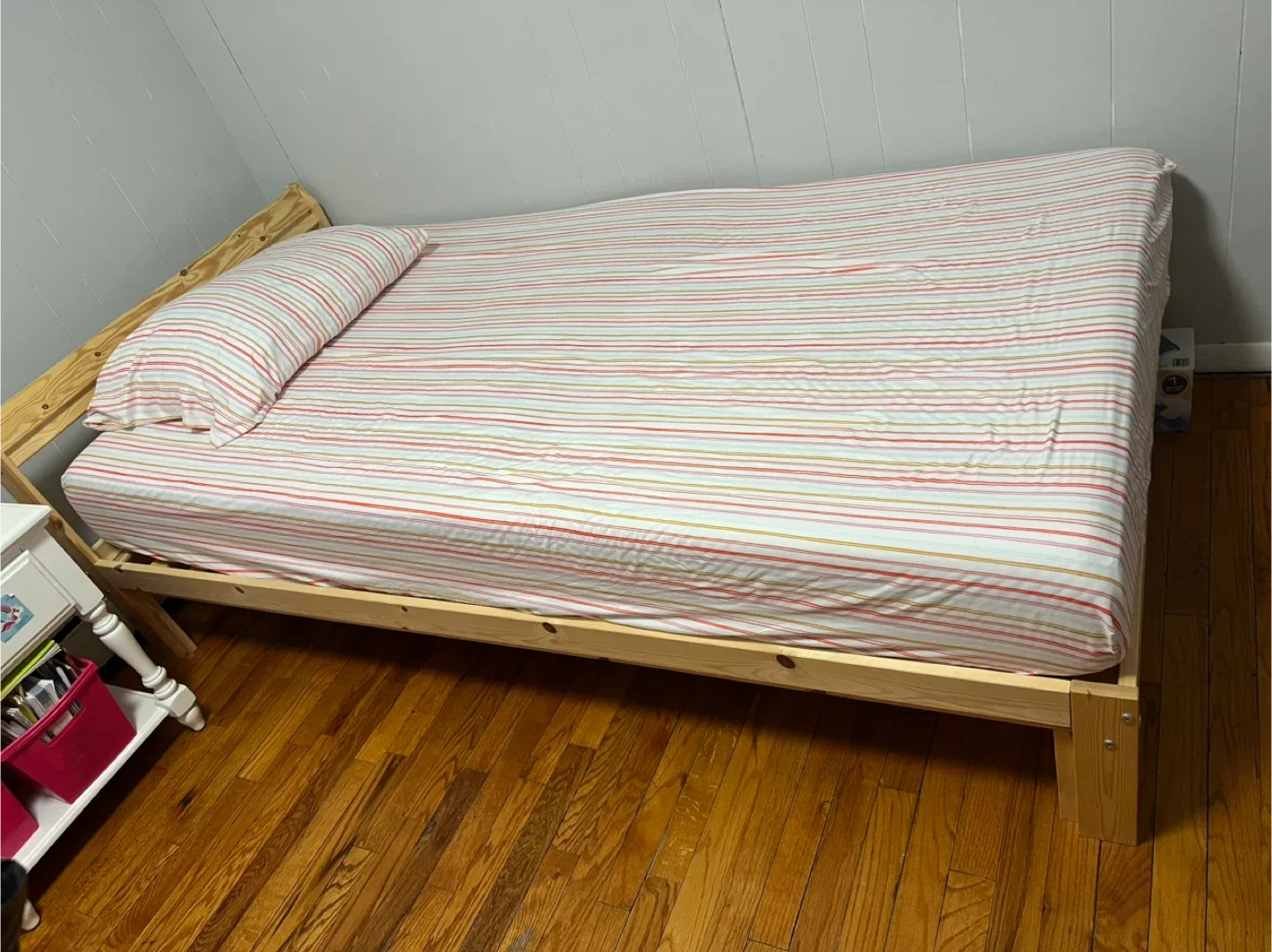Wooden Bed Frame with Striped Bedding