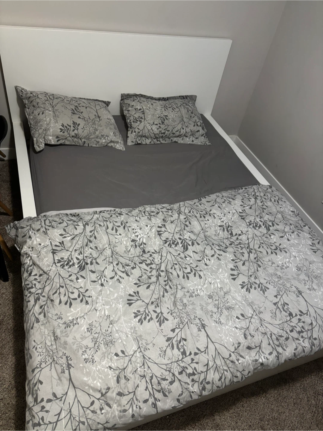 White Bed Frame with Grey Bedding & Floral Pillows