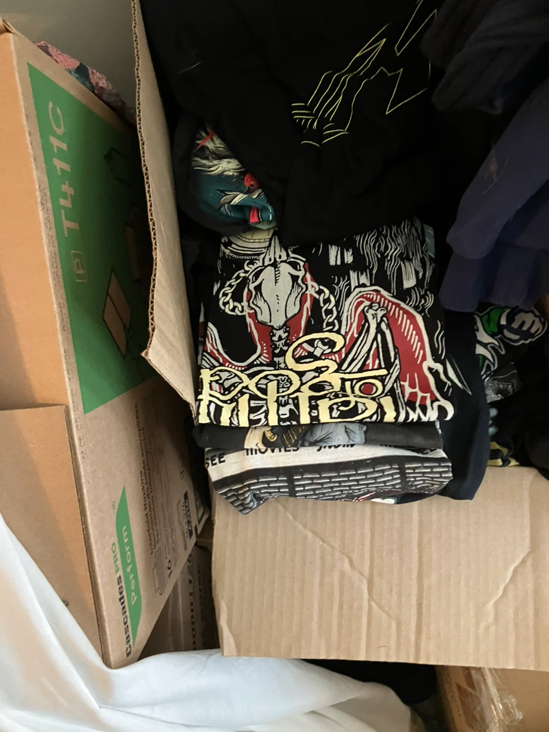 Box of assorted new concert t-shirts