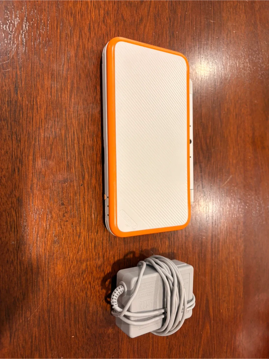 Nintendo 2DS handheld console with charger image indicator(2)