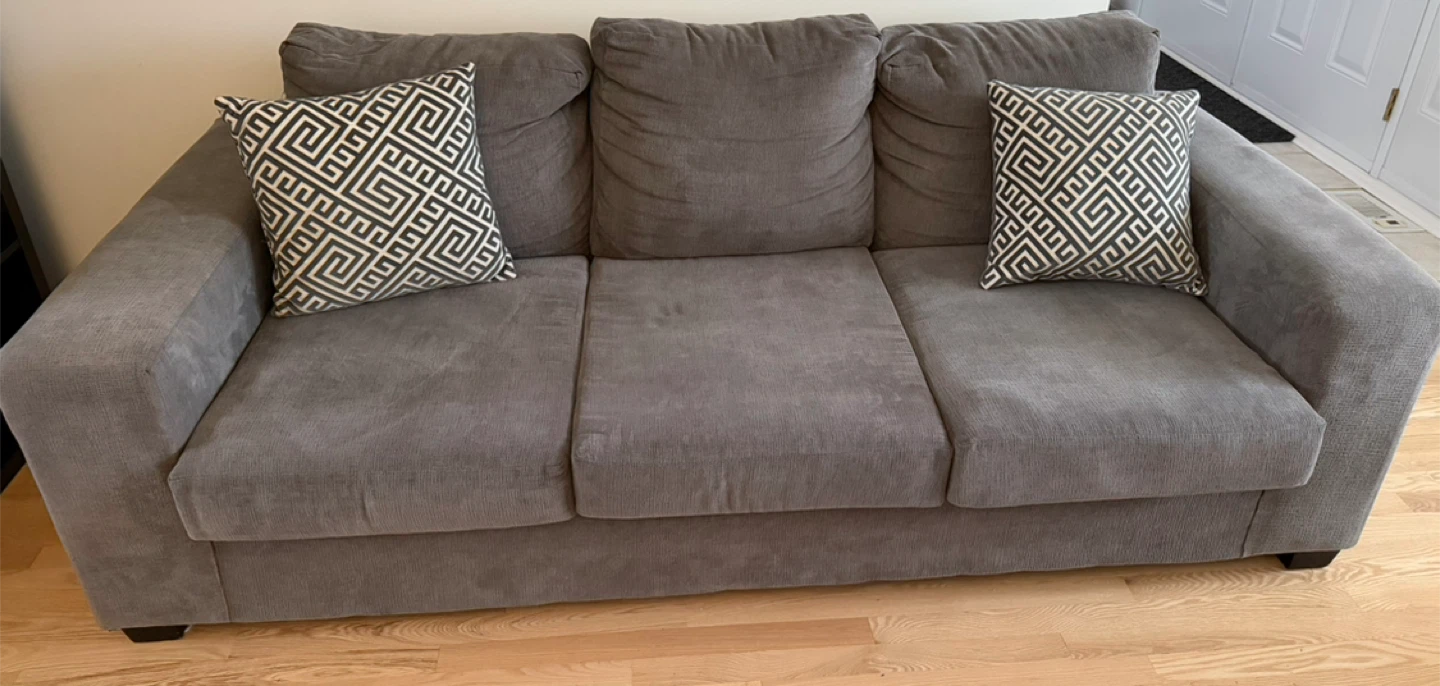 Grey Three-Seat Sofa with Pillows