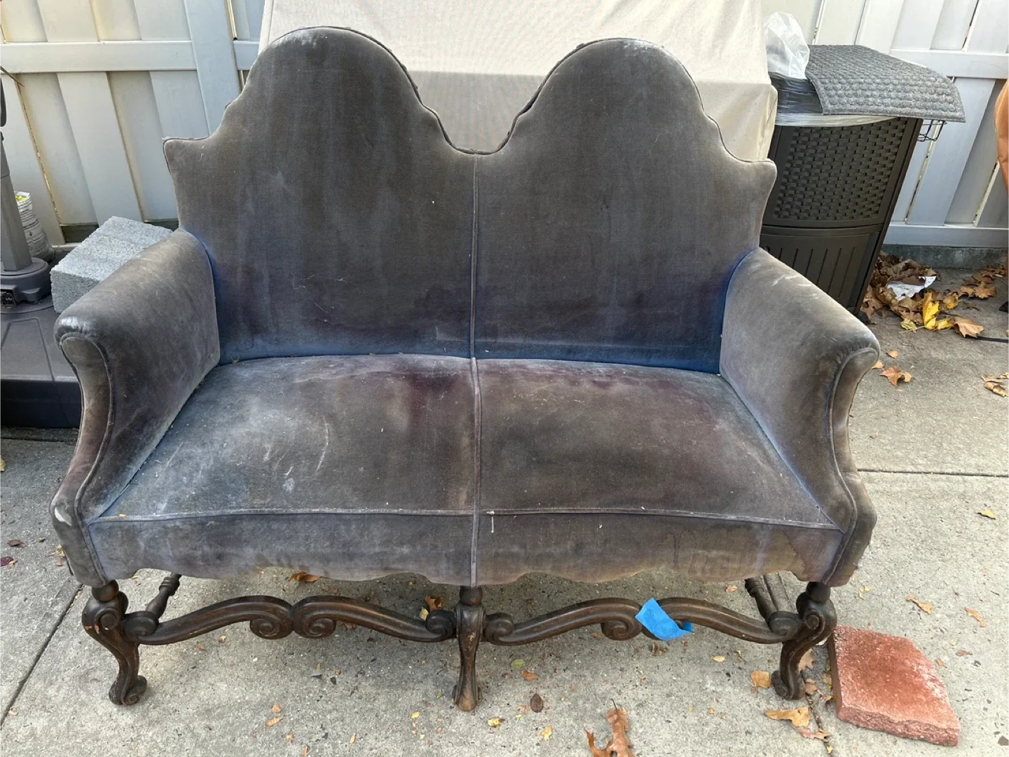 vintage or antique velvet settee with a carved wood frame