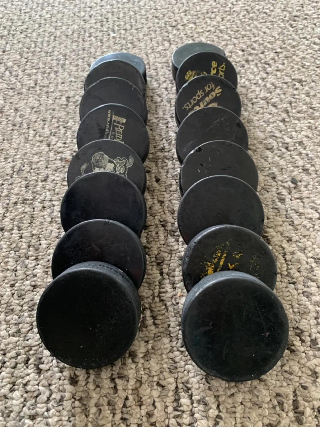 16 used Hockey Pucks - sports equipment
