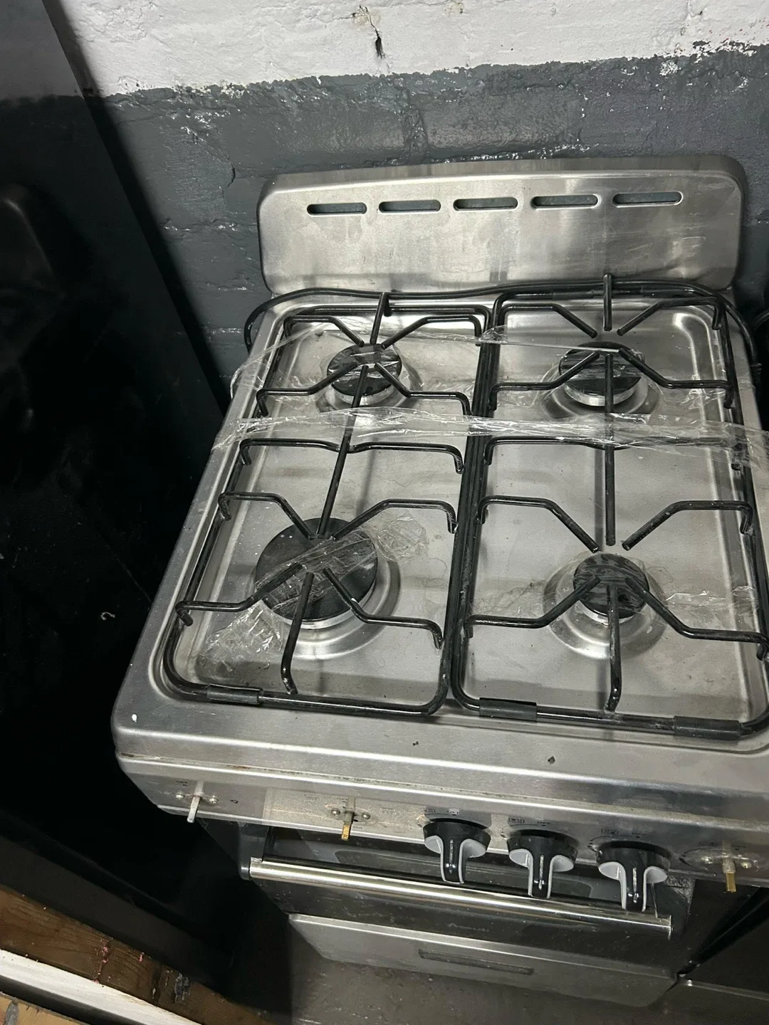 Stainless steel free standing refrigerator and one gas stove.. image indicator(5)