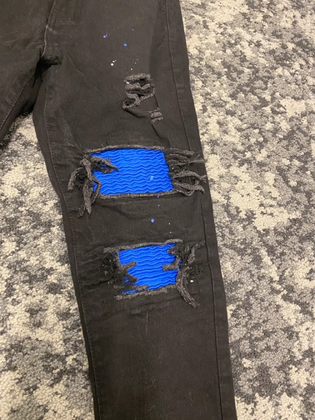 Black Ripped Jeans with Blue Patches image indicator(2)