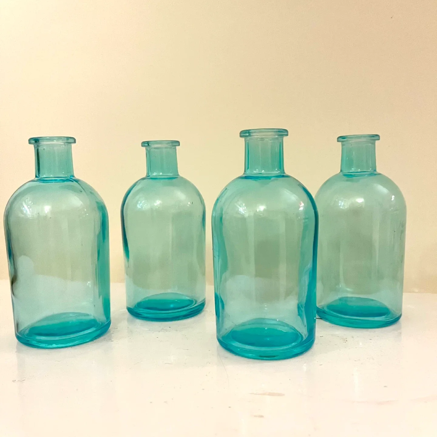4 blue glass apothecary-style bud vases