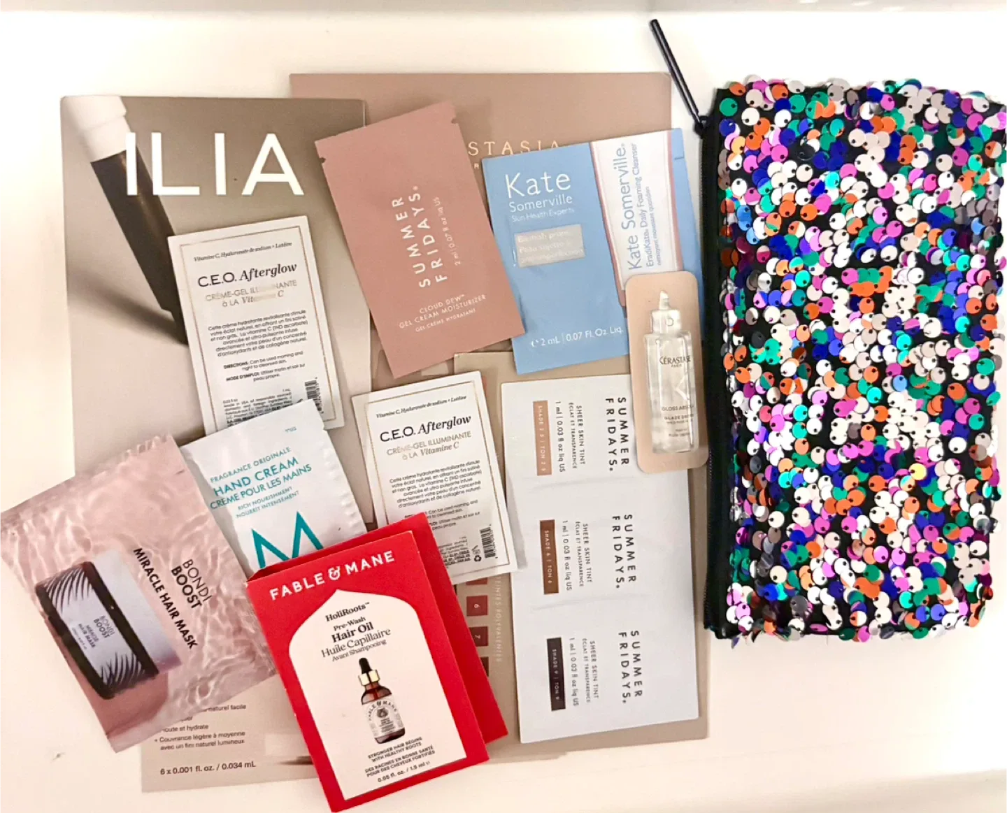 Assorted beauty sample bundle with MAC glitter pouch ✨