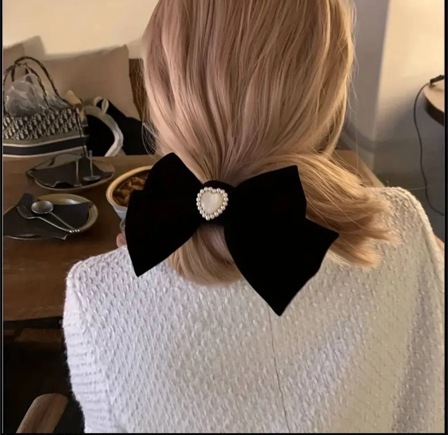 Black velvet bow with a pearl heart