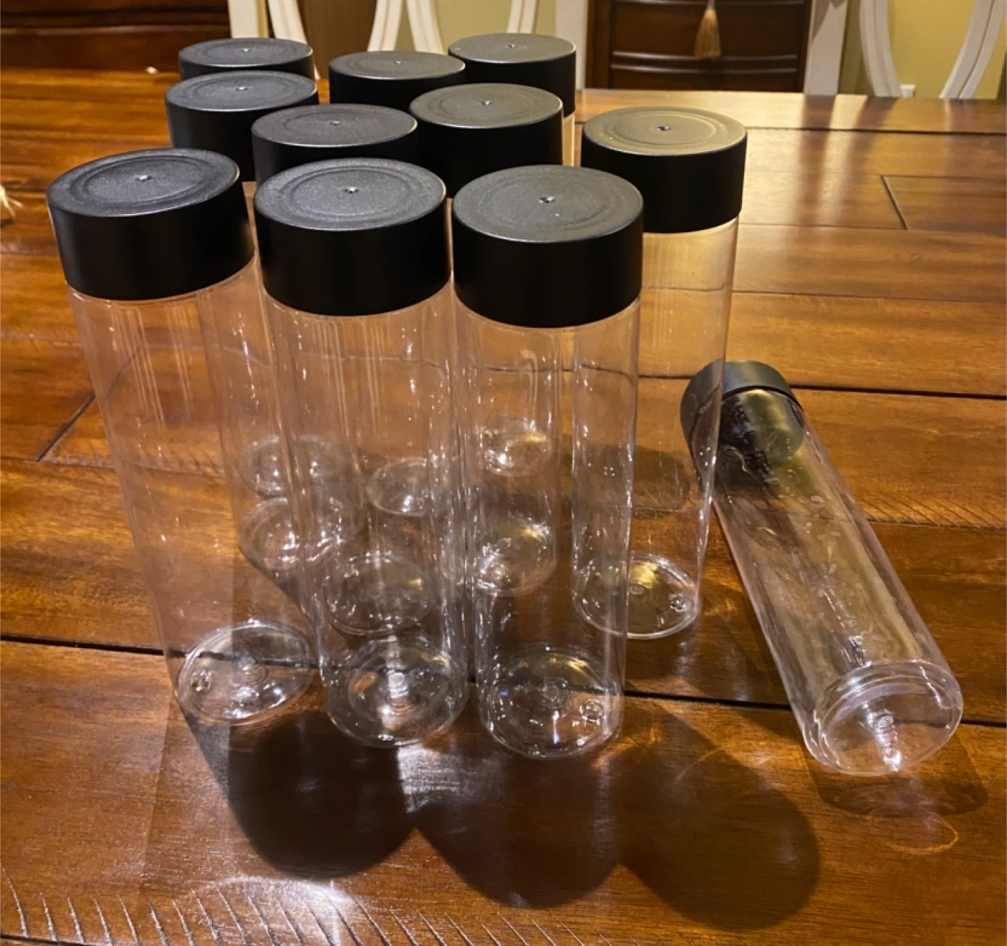 11 Reusable Clear Plastic Water Bottles with Black Lids