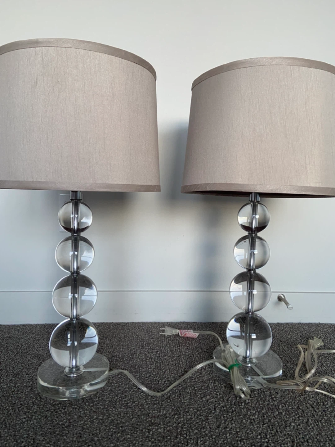 Pair elegant lamps with clear glass ball base.
