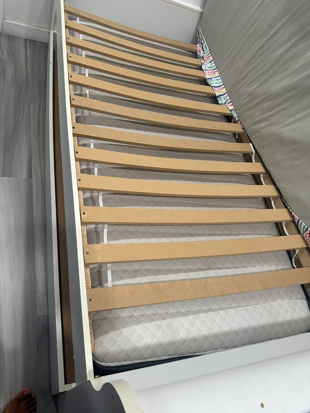 White bed with a cabinet in the bottom image indicator(2)