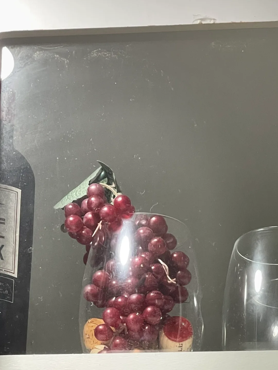 Artificial Red Grapes in Glass Vase