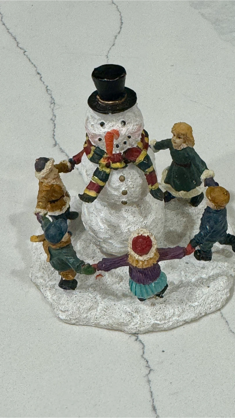 Snowman Figurine with Children Circling Around