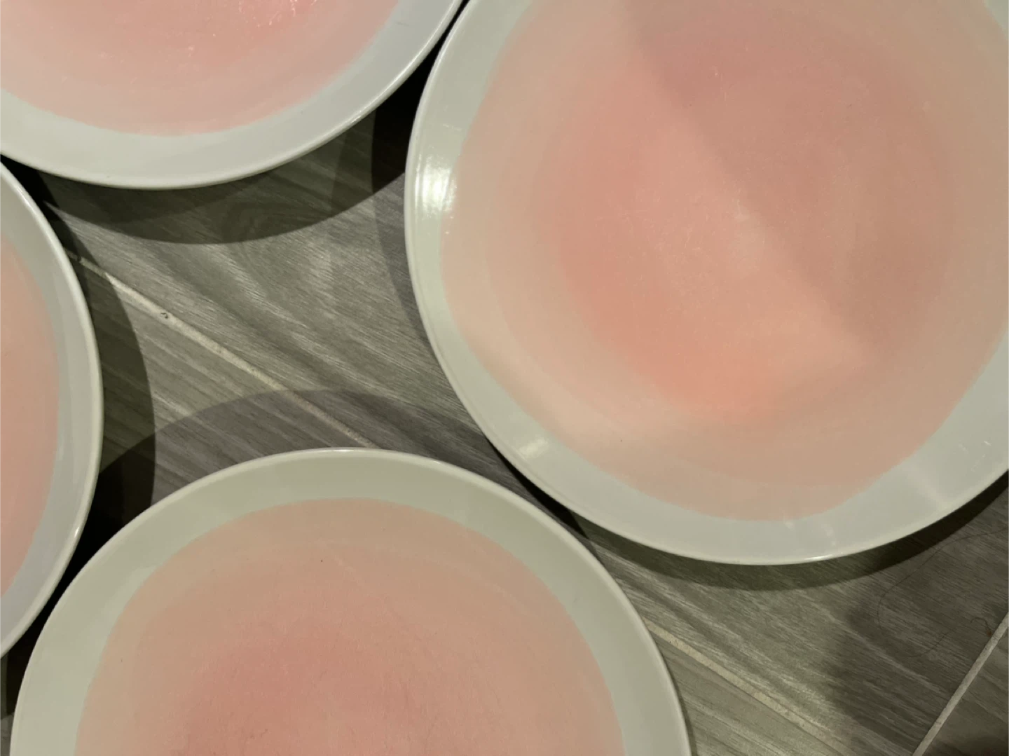 Four pink and white dinner plates