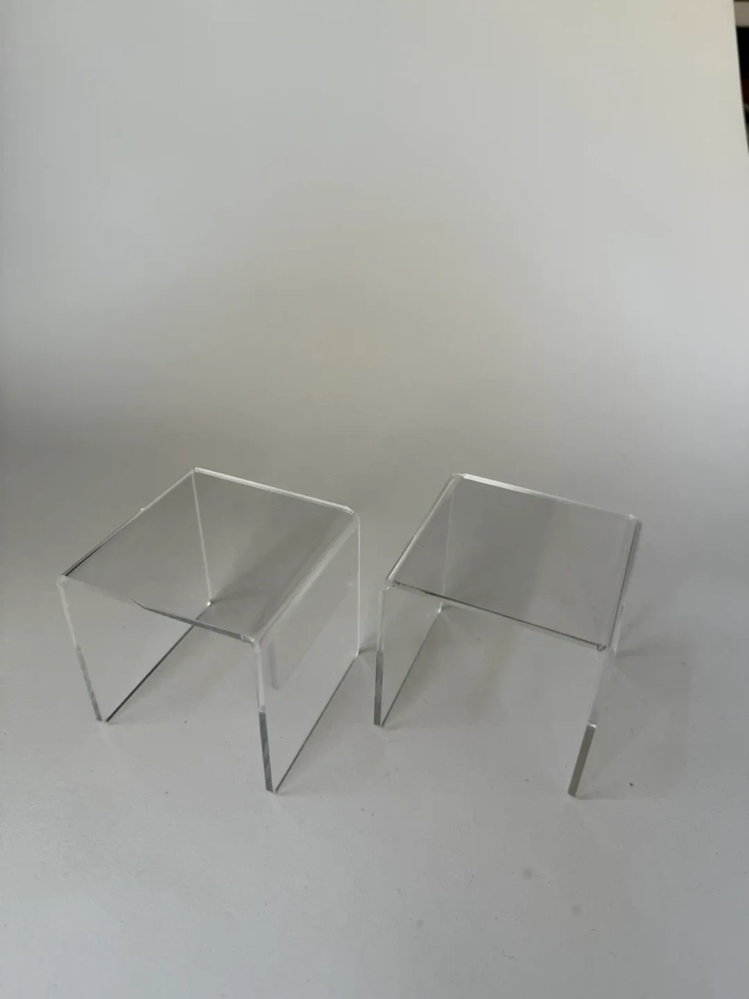 Two small acrylic risers