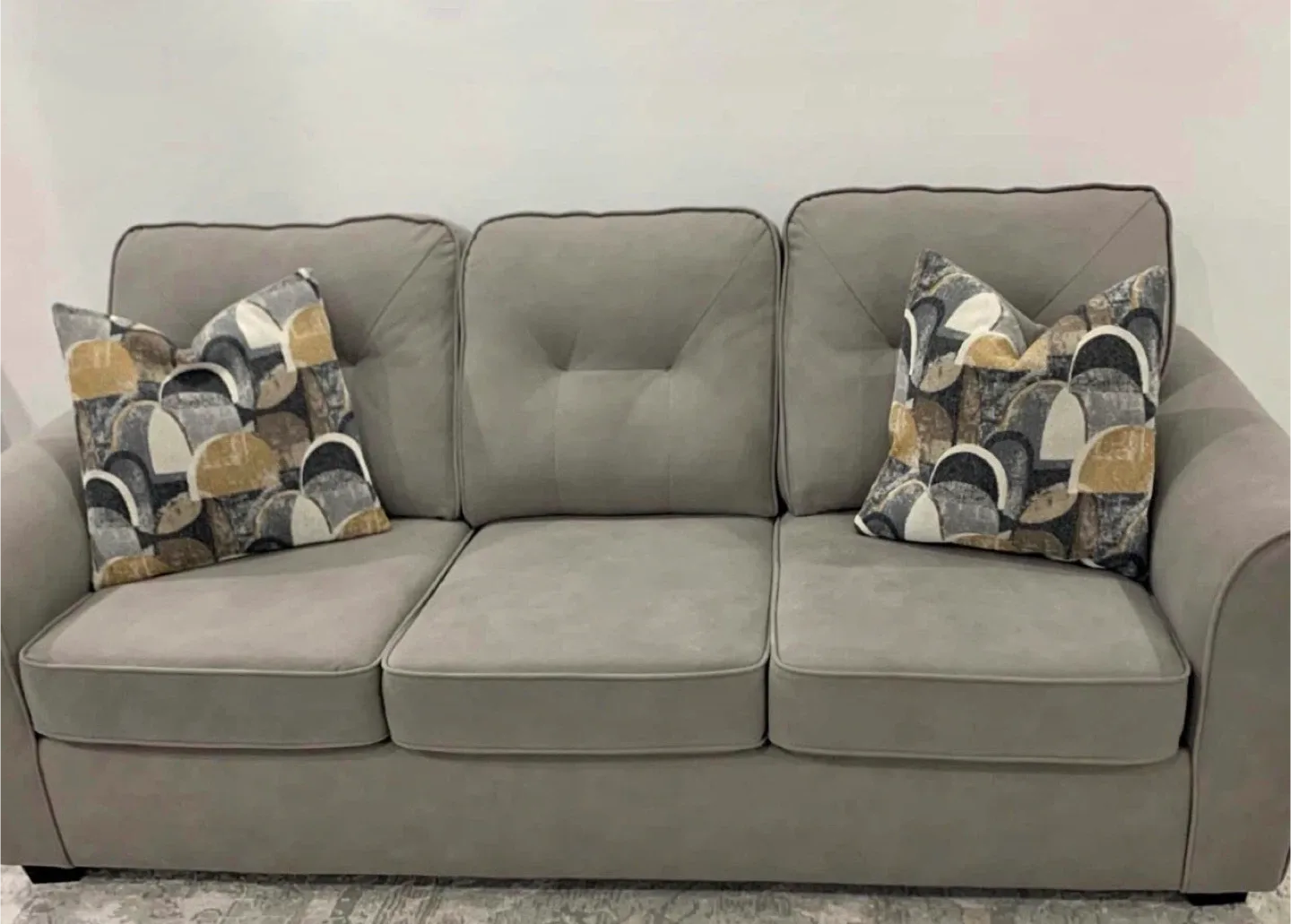 Grey Sofa with Two Throw Pillows