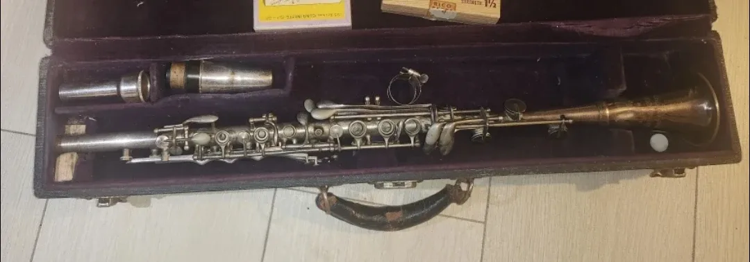 Vintage metal clarinet in its case, along with a box