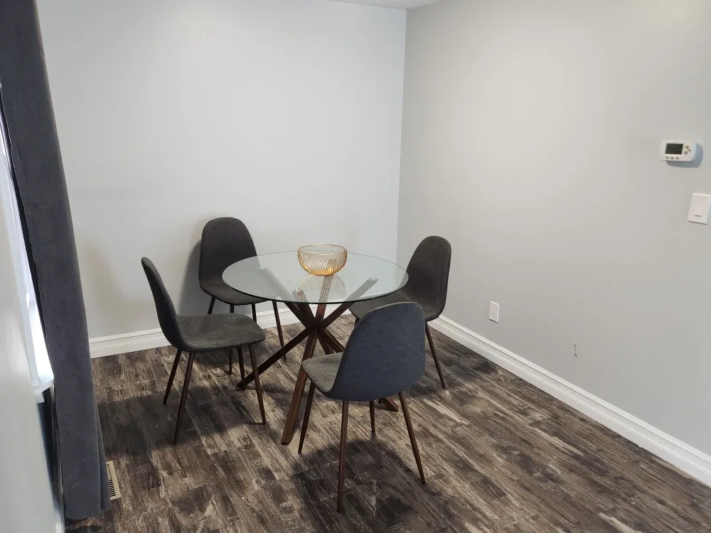 Round Glass Dining Table with 4 Grey Chairs image indicator(2)