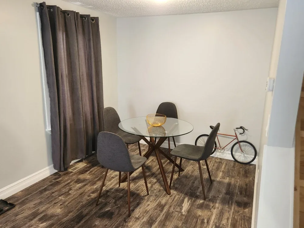 Round Glass Dining Table with 4 Grey Chairs image indicator(3)