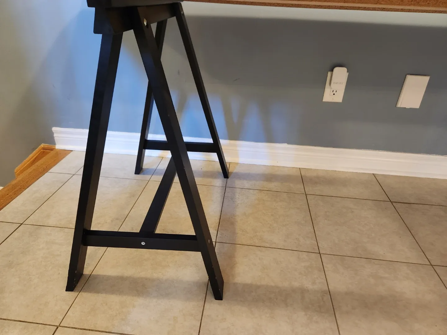 White  counter top table with black trestle legs image indicator(2)
